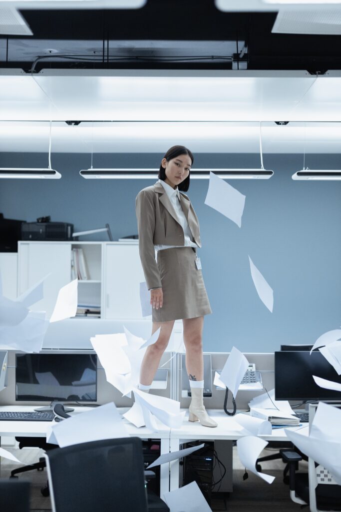 Woman in Beige Blazer Standing Near White Table